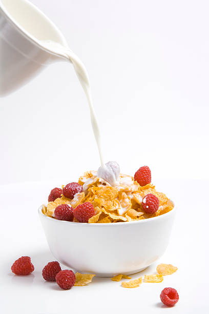 istock Pouring milk over cornflakes and raspberries 173756589