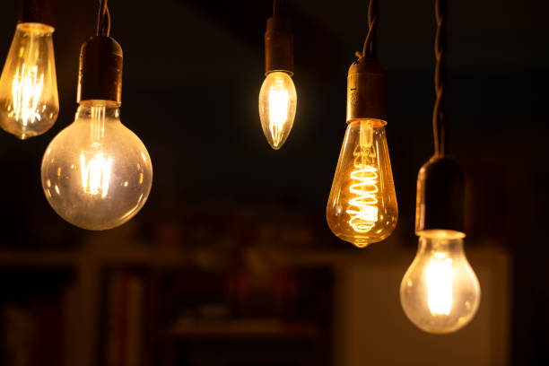istock Retro light bulbs hanging on a dark background. Electricity, Vintage 1737573711