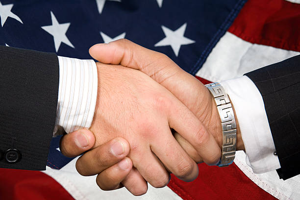 istock Businessmen Shake Hands with an American Flag Background 173757545