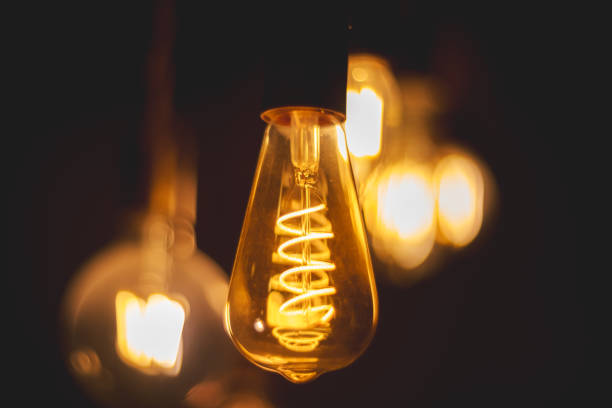 istock Spiral Retro light bulbs hanging on a dark background. Electricity, Vintage 1737575912