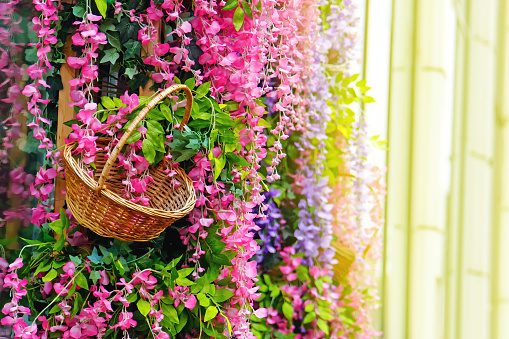 Wicker basket surrounded by flowers