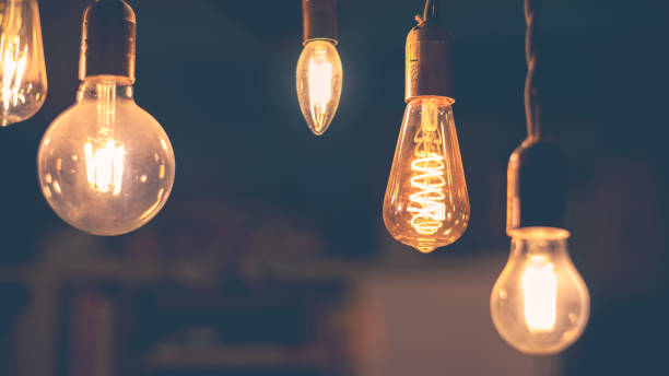 istock Retro light bulbs hanging on a dark background. Electricity, Vintage 1737579120