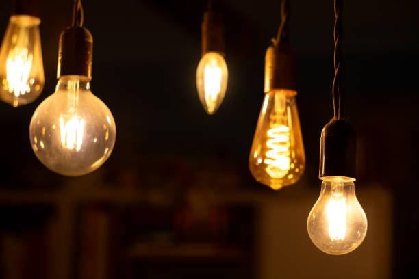 istock Retro light bulbs hanging on a dark background. Electricity, Vintage 1737580152