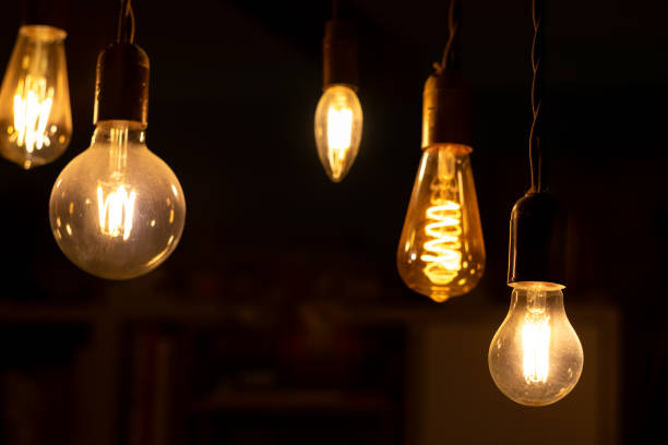 istock Retro light bulbs hanging on a dark background. Electricity, Vintage 1737580173