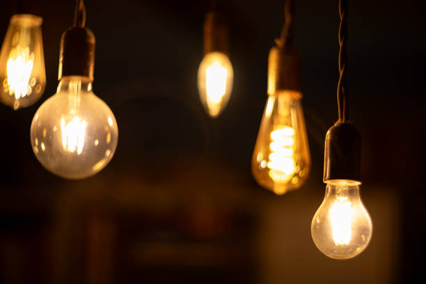 istock Retro light bulbs hanging on a dark background. Electricity, Vintage 1737580693