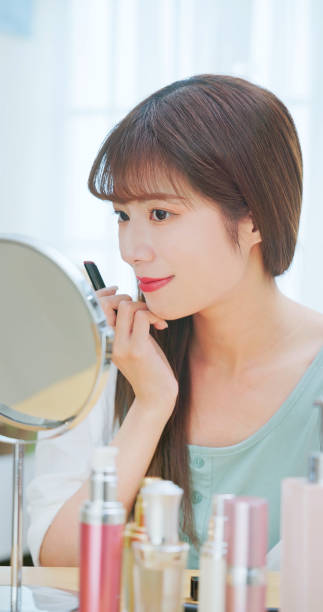 istock woman applying lipstick 1737584052