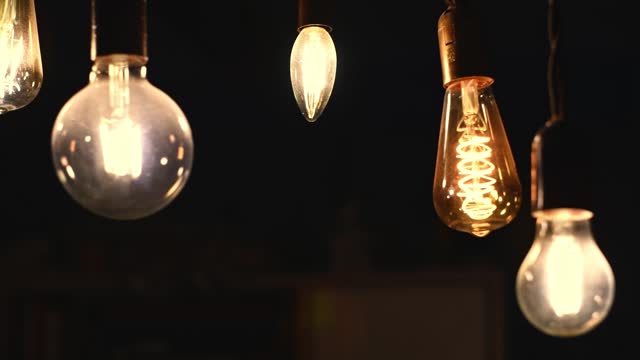 Retro light bulbs hanging on a dark background. Electricity, Vintage