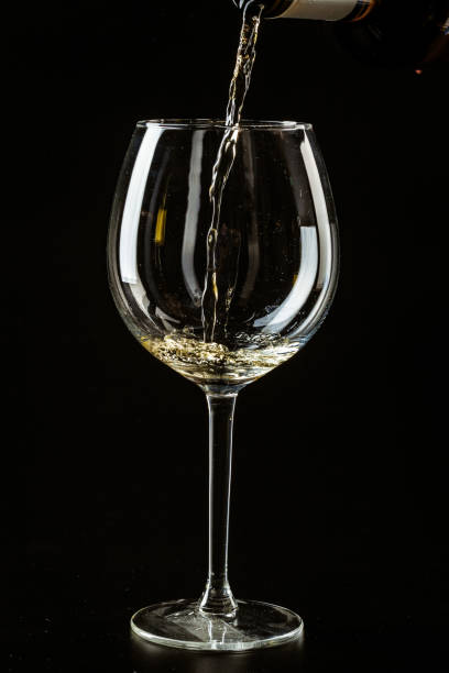 istock White wine being poured in a wine glass on a dark background 1737586237
