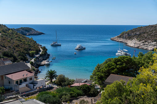 Boats anchored in the bay of small village on island Bisevo, Croatia.  It is near island Vis,  Dalmatia coast on Adriatic Sea as part of Mediterranean.