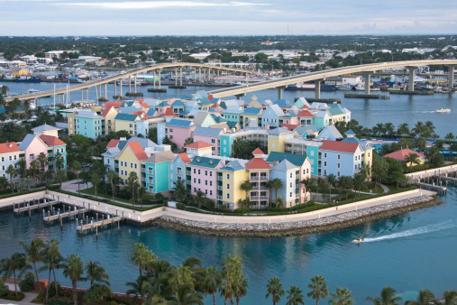 A view of Paradise Island accross the bridge from Nassau in the Bahamas showing the blue waters surrounding a very colorful Condominium Complex visited by tourists from all over the world.