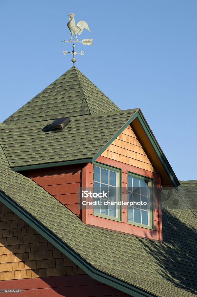 Roof gable and rooster weather vain "Vertical, dark green gable roof with rooster weather vain.  Cedar shingles and coral siding." Cedar Tree Stock Photo