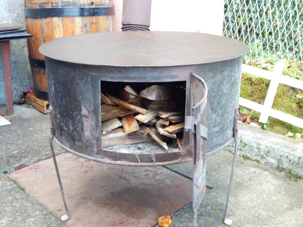 istock Fire wood in small black iron stove 1737594522