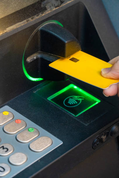 Closeup, hand insert the credit card in the ATM