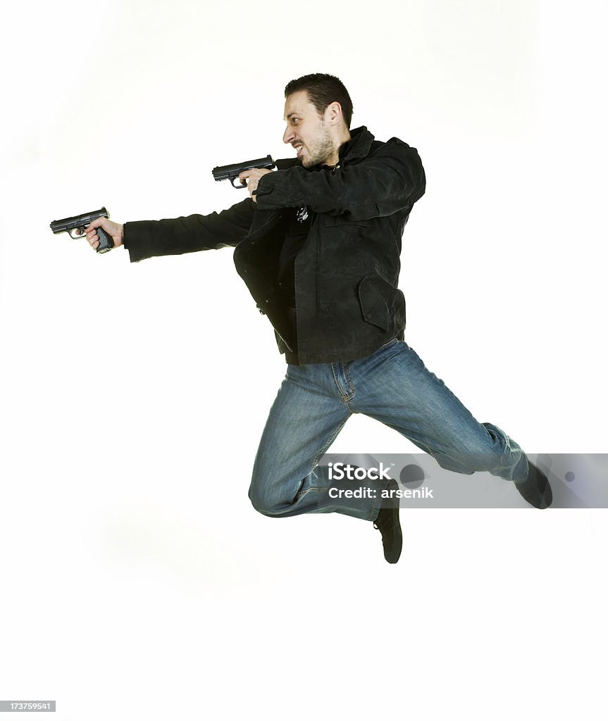 Action star Guy flying through air with guns blazing. Activity Stock Photo