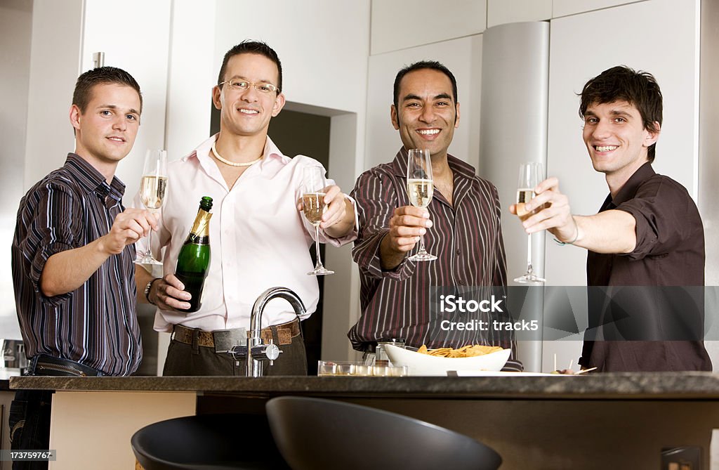 cheers A group of friends toast the camera with a glass of champagne. Casual Clothing Stock Photo