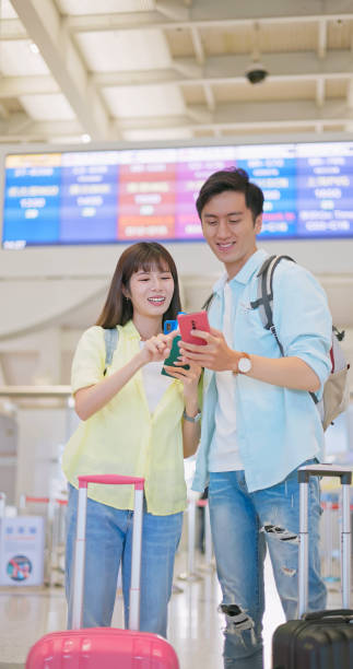 istock Couple view cellular at airport 1737598744