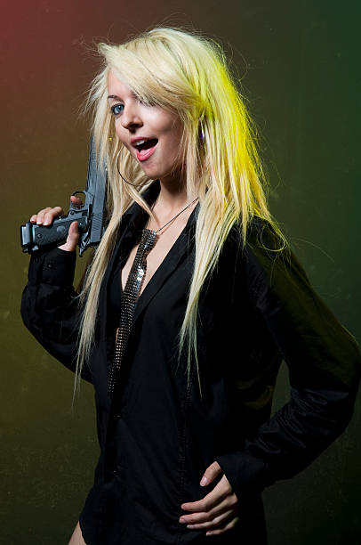 istock sexy blond woman with gun 173760627