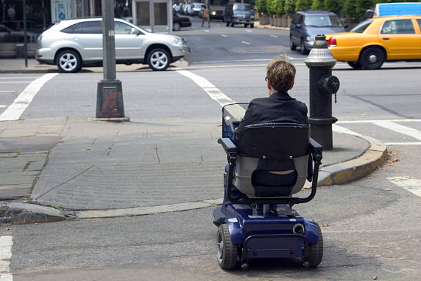 disabled crossing the street stock photo