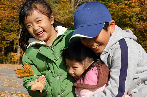 Three kids playing together and hugging each others