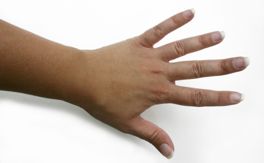 Woman's hand with fingers spread on white background.