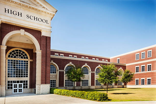 Education:  High school building entrance.  Copyspace and sky. stock photo