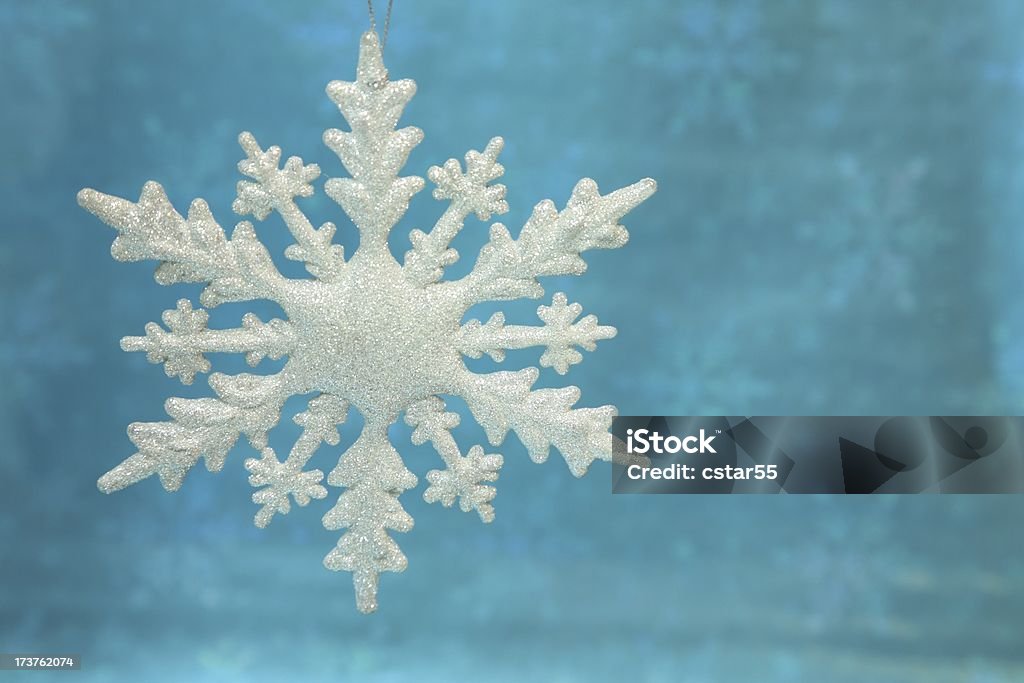 Snowflake Ornament Sparkling snowflake Christmas ornament on a luminous turquoise background.Click to see other Christmas images.. Backgrounds Stock Photo