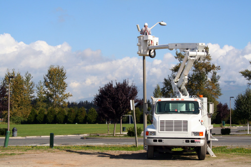 Utility worker installing a close-circuit video camera.