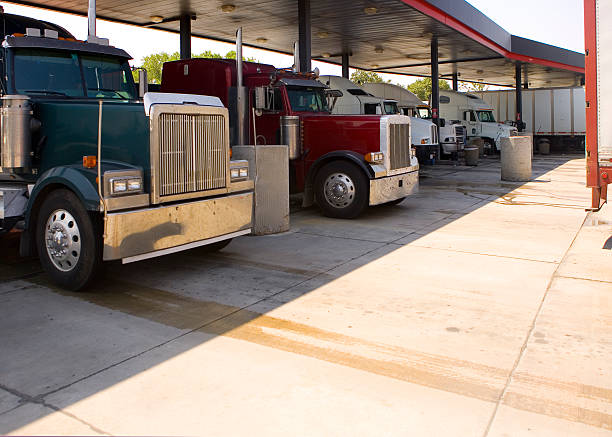 Several trucks at a rest stop gas station filling up tanks Big rigs refuel at a major truck stop diesel fuel stock pictures, royalty-free photos & images