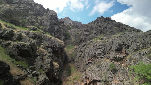 Aerial up jagged rocky canyon wall of Hells Canyon above Snake River in Idaho