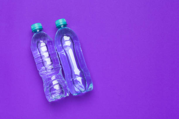 istock Water bottle flat lay top view on color paper background 1737627664