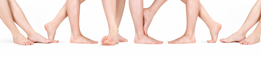 Closeup of female legs with dry itchy skin against white background