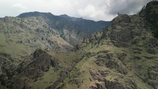 Aerial view of forested canyon walls of mountains in Hells Canyon Recreation Area in Idaho above Snake River