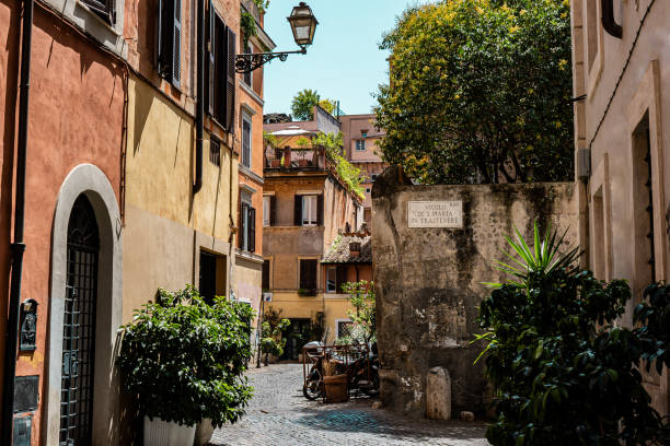 istock Buildings with potted plants in Travestere. Charming facade with shutters. Paved sidewalk 1737645677