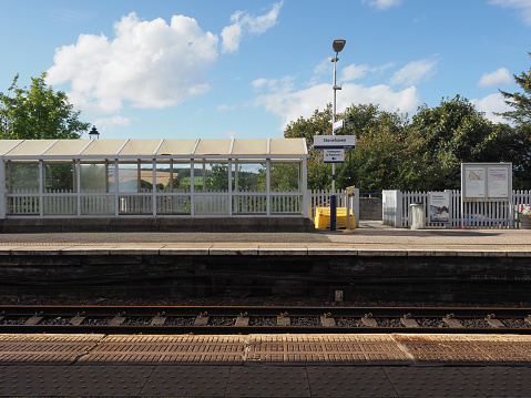 Double railway lines and platform in a rural English countryside railway station