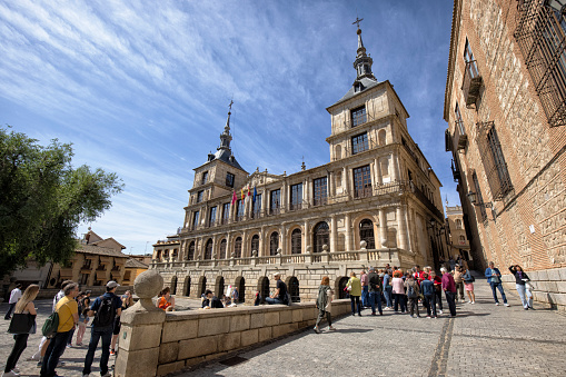 Exterior view of Toledo City Hall, Spain. Many tourists can be seen.