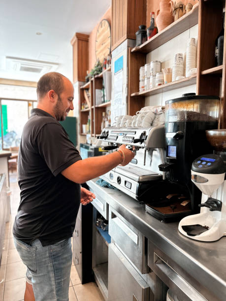 istock Waiter preparing a coffee in a rural village bar 1737671713