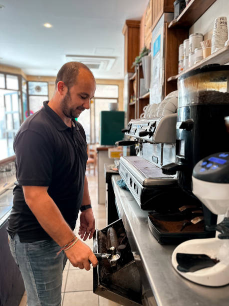 istock Waiter preparing a coffee in a rural village bar 1737676642