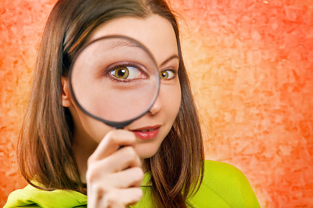 istock woman with magnifying glass 173769006