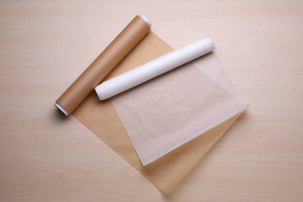 istock Rolls of baking paper on wooden table, flat lay 1737695132