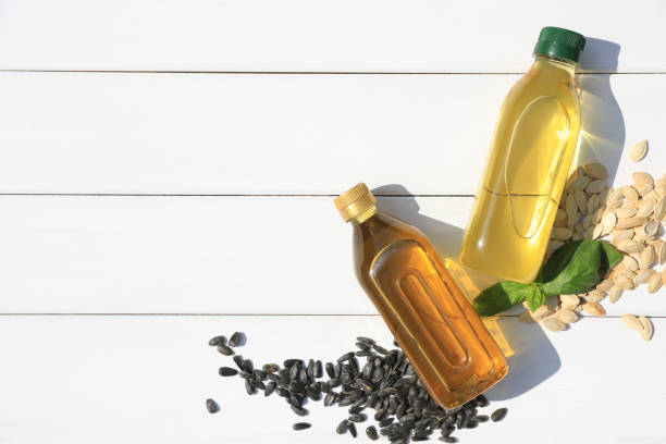istock Different cooking oils and seeds on white wooden table, flat lay. Space for text 1737696225