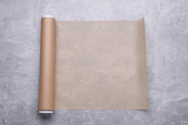 istock Roll of baking paper on light grey table, top view 1737696258