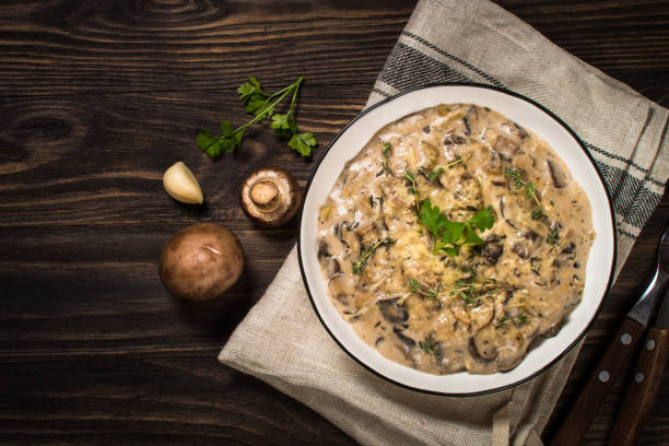 istock Champignons in cream sauce at white table. 1737699476