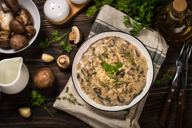 istock Champignons in cream sauce at white table. 1737699483