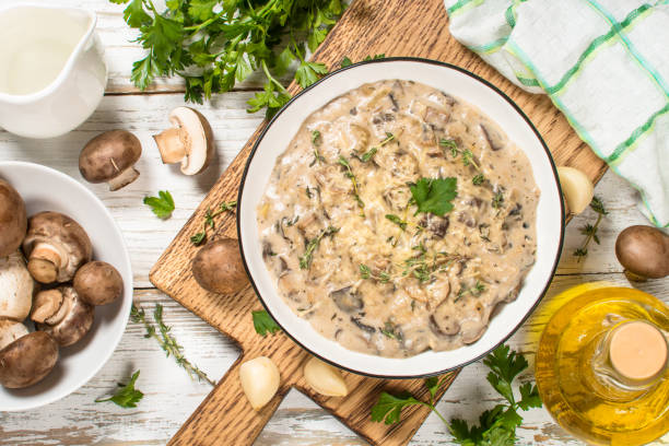istock Champignons in cream sauce at white table. 1737699485