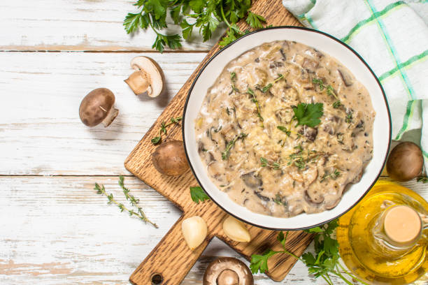 istock Champignons in cream sauce at white table. 1737700557