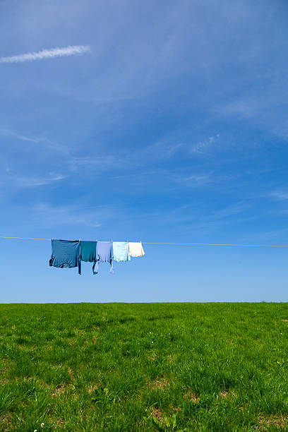 Clothing on washing line, cloudy blue sky in background