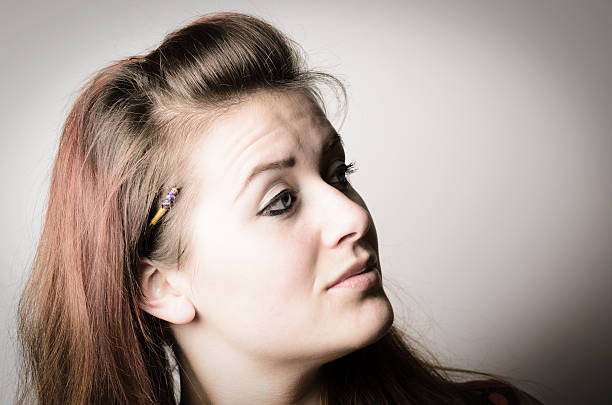 istock Young Woman Looking Away from Camera and Raising Eyebrow 173770658