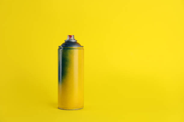 istock Used can of spray paint on yellow background. Space for text 1737714859