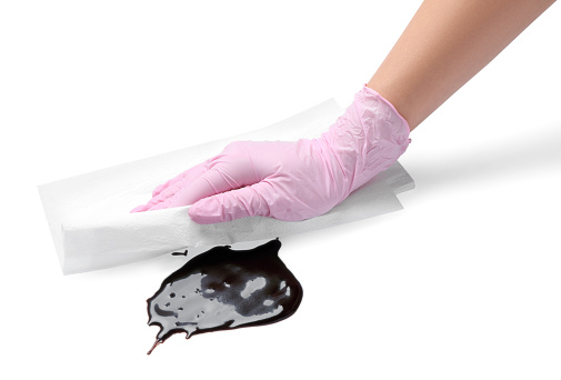 Woman wiping melted chocolate on white background, closeup
