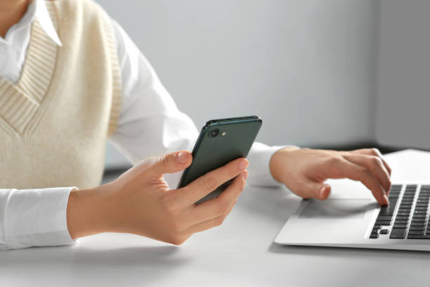 istock Woman using smartphone at table indoors, closeup 1737732029